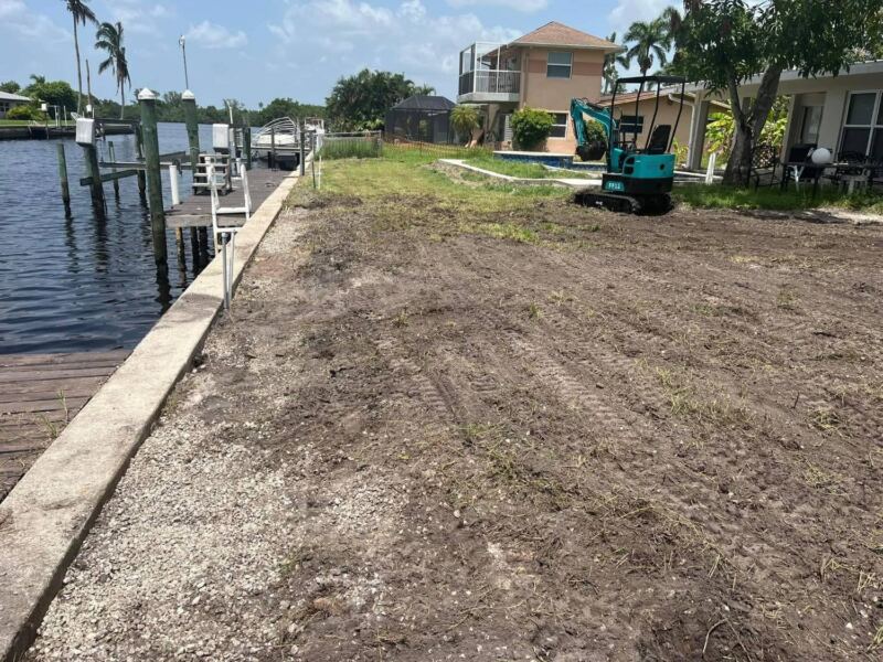 Canal-front yard stripped and graded along the seawall, before new sod