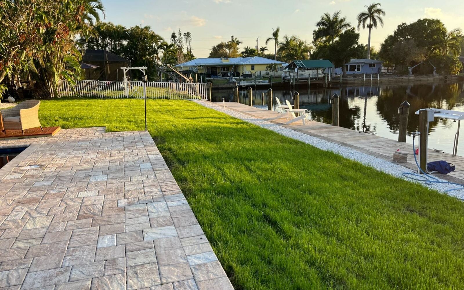 Paver walkway beside a new lawn on a Southwest Florida canal-front property