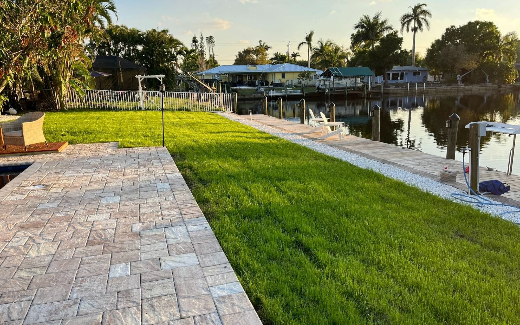 Paver walkway beside a new lawn on a Southwest Florida canal-front property