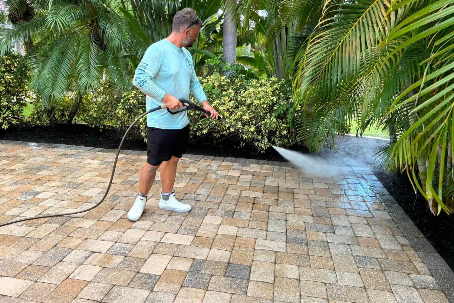 Pressure washing a paver driveway