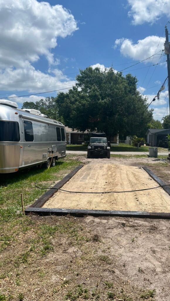 RV pad framed with timbers and a leveled base, in progress