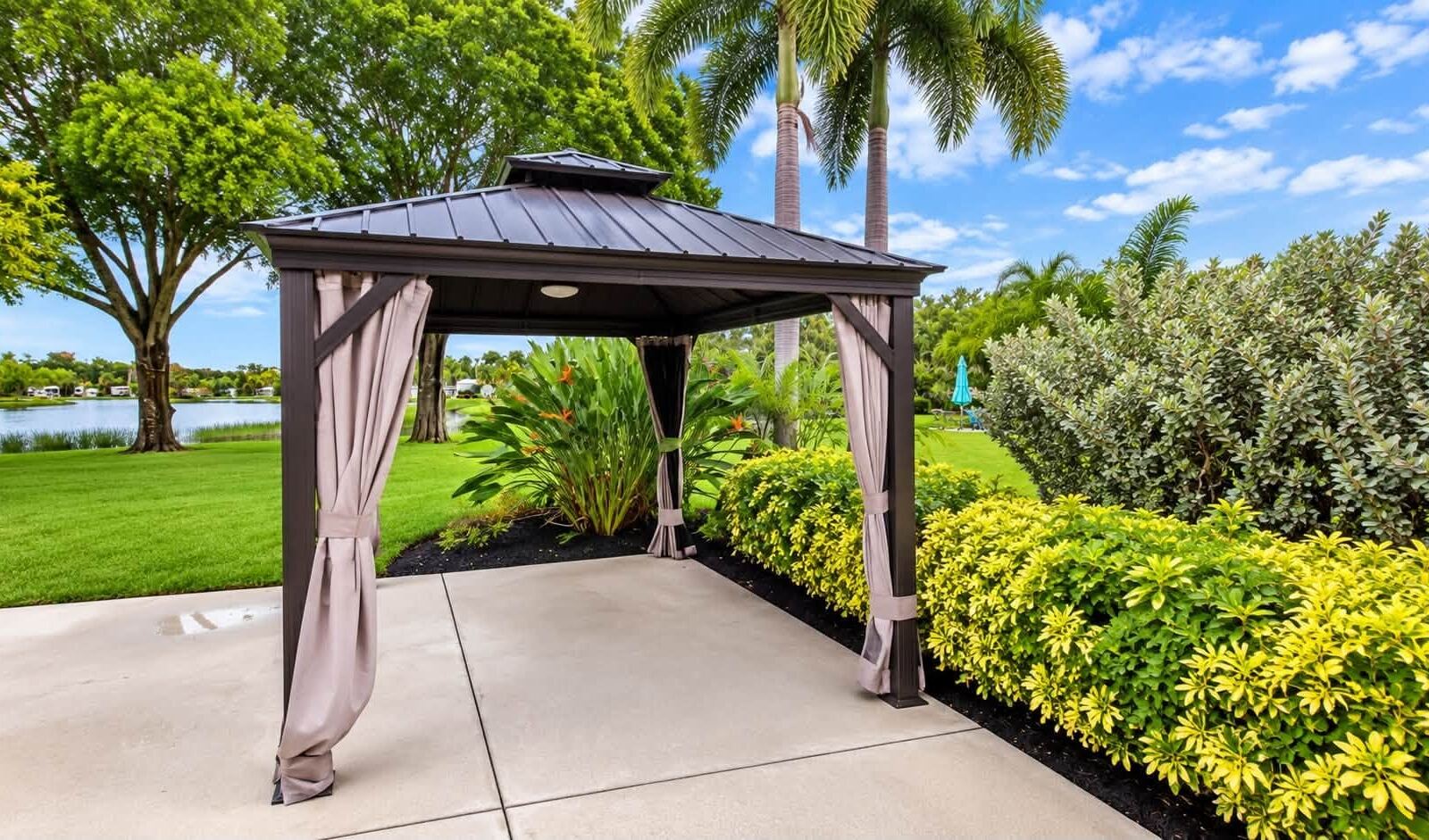 After: cleaned concrete pad and trimmed hedges around a gazebo