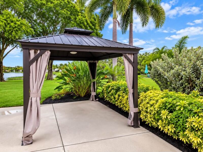 After: cleaned concrete pad and trimmed hedges around a gazebo